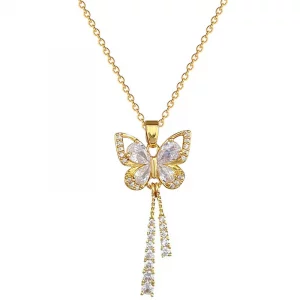 Un collier en or avec un pendentif papillon et un pompon.
